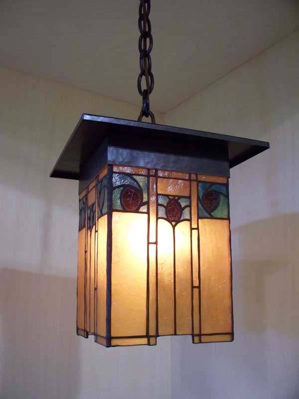 arts and crafts style lantern with hammered copper and art glass